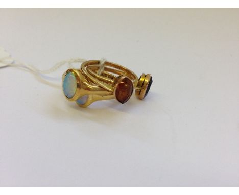 A pair of 18 carat gold and opal set rings together with a pair of 9 carat gold dress rings (these rings originally owned by 