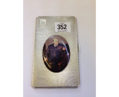 An engine turned silver cigarette case, decorated with a portrait medallion of Sir Winston Churchill (264 grams overall).