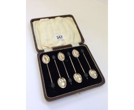 A cased set of six silver bean finial coffee spoons.