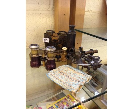 A collection of various binoculars, scientific instruments and a bead purse.