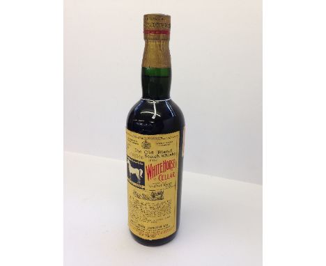 A 1960 bottle of White Horse Scotch Whisky, 70% proof, Serial No. 1006506.