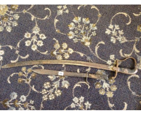 A bayonet together with a sabre and a copper and brass bugle.