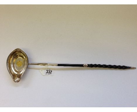 A large silver Toddy ladle with inset French 20 Francs gold coin, dated 1808 with twist silver mounted ebony stem.