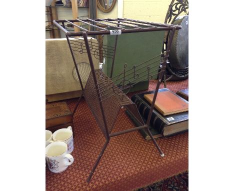 A mid 20th century wirework record player stand with treble clef design and record rack under.