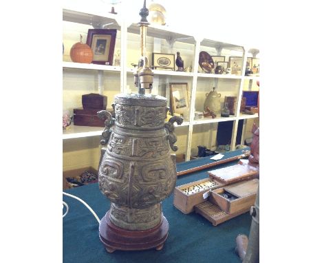 A Burmese bronze figural lamp base with stylised decoration. 