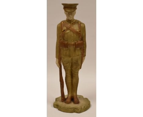 ROYAL WORCESTER FIGURE OF A STANDING WWI ARMY OFFICER in blush glaze with rifle, standing to attention, 19cms high