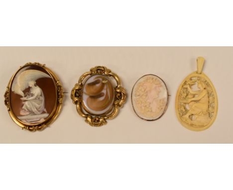 A LARGE CAMEO BROOCH OF MYTHOLOGY WITH ROBED FIGURE FEEDING LARGE EAGLE, in a yellow metal frame, 7cms long, together with a 