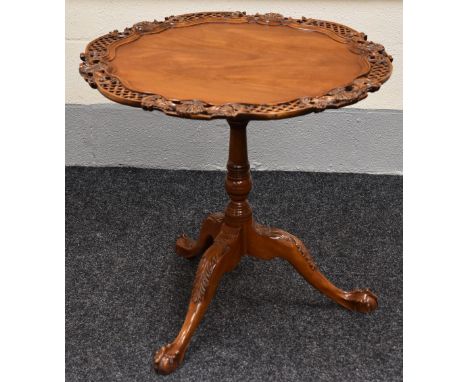 ORNATELY CARVED AND PIERCE REPRODUCTION TILTING TABLE with centre column tripod ball and claw feet, 76 x 70 cms