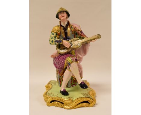 A RARE MINTON FIGURE OF A 'SPANISH' GUITAR PLAYER, model number 94 wearing richly decorated costume and seated on a Chinese g