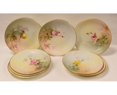 SET OF NINE ROYAL WORCESTER PLATES, of circular form with gilded borders and painted with wild roses, shape No.2, date mark f