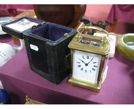 A French Brass Cased Carriage Clock, white enamel dial, Roman numerals, bevelled glass plates with arched carrying handle, in