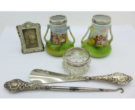 A pair of silver mounted vases, a silver handled button hook, a shoe horn, etc., (frame a/f)