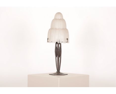 AN ART DECO LAMP WITH EDGAR BRANDT STYLE BASEwith textured hexagonal foot with three-tier waterfall shade stamped Sabino 4645