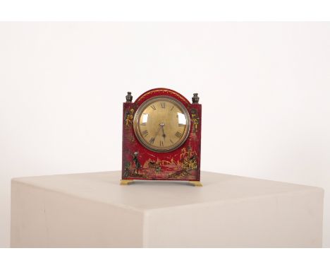 A CHINOISERIE MANTEL CLOCK 20th century, of red ground with an arched top, decorated with figures amongst pagodas, on bracket