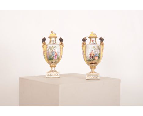 A PAIR OF 'HELENA WOLFSOHN' STYLE PORCELAIN TWO HANDLED URNS late 19th century, the covers with bud finials, the bodies decor