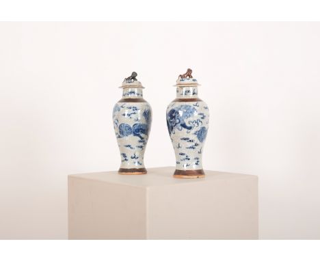 A PAIR OF CHINESE BLUE AND WHITE CRACKLEWARE PORCELAIN VASES early 20th Century, decorated with kylins and cloud bands, the c