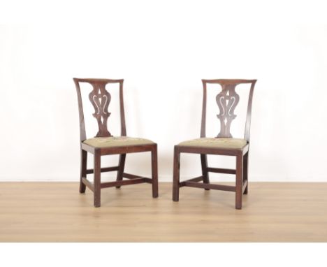 A PAIR OF MAHOGANY 'CHIPPENDALE' HALL CHAIRS18th century, the shaped cresting rails over pierced vase shaped backs, over drop