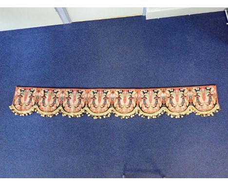 A WOOLWORK MANTELPIECE PELMET, THREE SCALLOP EDGED PANELS WITH BOBBLE FRINGE re-backed 209 cm long (some areas of moth damage