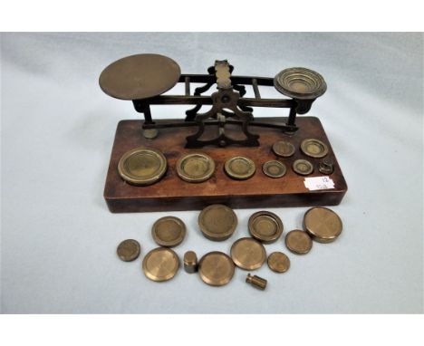 A SET OF VICTORIAN BRASS POSTAL SCALES with weights and extra weights