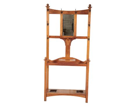 AN EDWARDIAN OAK AND METAL MOUNTED HALL STAND, IN ARTS AND CRAFTS STYLE early 20th century, the back with concave topped uppe