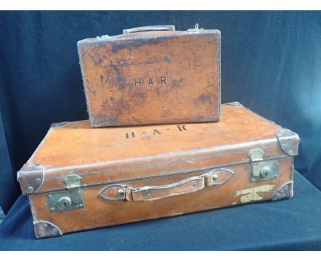 A VINTAGE LEATHER SUTCASE 67 cm WIDE, AND ANOTHER SMALLER (larger needs handle repair)
