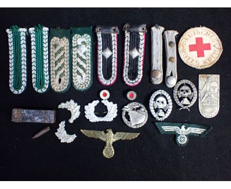 A COLLECTION OF NAZI STYLE MILITARY BADGES epaulettes and other militaria