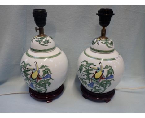 A PAIR OF TABLE LAMPS IN THE FORM OF CHINESE GINGER JARS AND COVERS on wooden stands 24 cm high, plus fittings