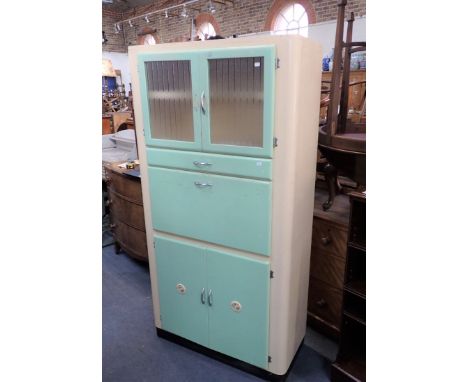 A VINTAGE 1950S 'LEBUS FURNITURE' KITCHEN CABINET with fold down glass topped flap, glazed doors and cupboards, in green and 