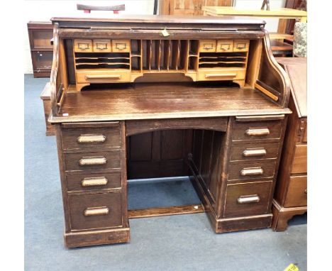 AN EARLY 20TH CENTURY OAK ROLL TOP DESK retailer's label, "Hannah &amp; Holland Dorchester", 127cm wide (with key )