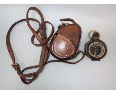 A WORLD WAR I BRASS COMPASS Varner's patent, dated 1918, with original leather outer case and strap