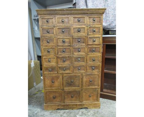 A modern hardwood thirty drawer collectors chest on bracket feet, 52"h, 32"w, 10"d 