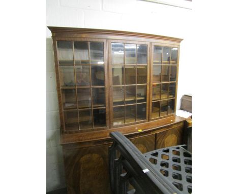 A reproduction mahogany bow fronted display side cabinet, three glazed display doors over a base with three cupboard doors on