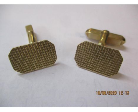 A pair of 9ct gold cuff links with engine turned decoration to the tablet, 8.4g 