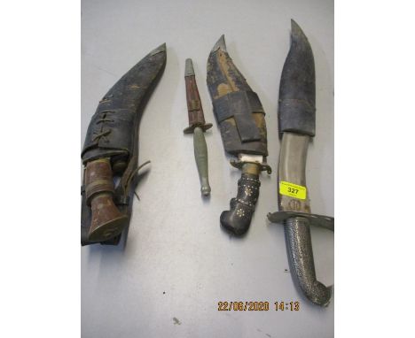 A WW2 commando fighting knife, possibly etched Wilkinson Sword London, together with three kukri knifes