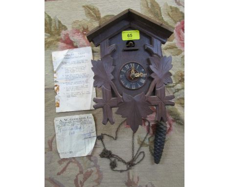 An early to mid 20th century Black Forest cased cuckoo clock with one weight, and original Gamage Ltd sales receipt dated 28 