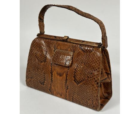 A Vintage 1930-50's Python skin hand bag with snap closure to top and three interior compartments and zip closure pocket. loo