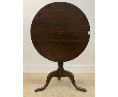 A George III oak snap top tripod table, the circular top over baluster turned column and triple splay supports with pad feet 