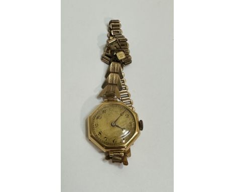 A Vintage lady's 1930's 18ct gold cased wrist watch with octagonal gilt dial on rolled gold bracelet. (d x 2cm)