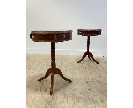 A pair of Georgian style hardwood drum table, the plate glass top over two frieze drawers, raised on a turned pedestal and tr