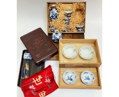 A mixed group of Japanese items including a blue and white porcelain sake set comprising two bottles (h- 10cm) and five cups 