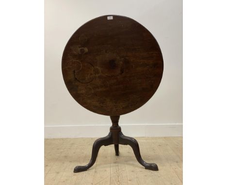 A George III mahogany snap top tripod table, the single plank circular top over baluster turned column and triple splay suppo