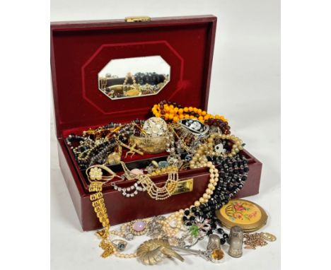 A jewellery box containing a collection of costume jewellery including a gilt metal hinged bangle, paste pearl necklaces, com