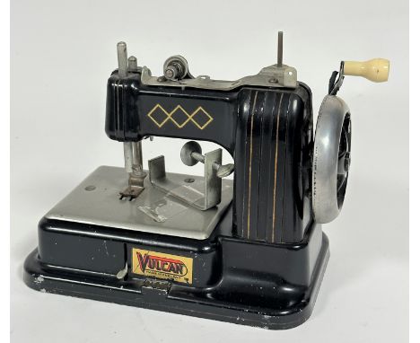 A Vulcan tinplate child's toy 1930-50's model table top sewing machine, some losses to black enamel to base. (h 18cm x l  20c