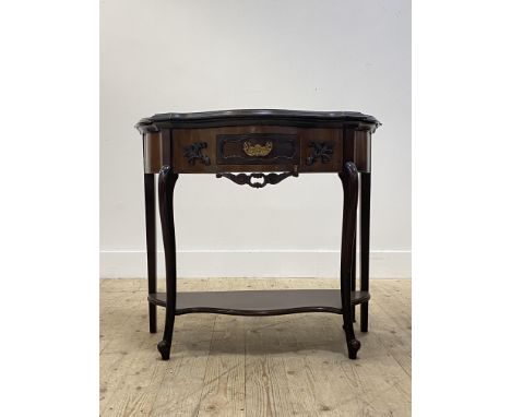 An Edwardian mahogany card table in the 18th century style, the serpentine top folding over to reveal a tooled baize lined pl