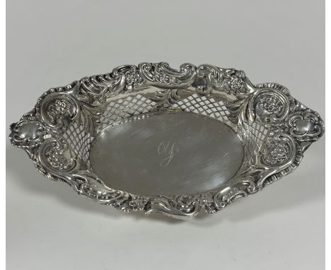 An Edwardian Chester silver navette shaped scalloped fruit basket with rococo C scroll, floral and leaf border to top and pie