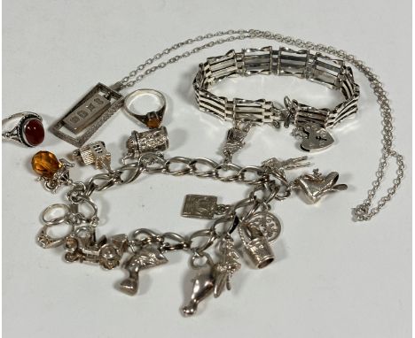 A collection of silver jewellery including an oval spiral link charm bracelet with thirteen various charms, a gatelink bracel