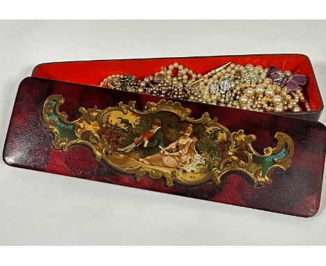 An Edwardian rectangular papier mache lacquered glove box with central panel of  seated lady and young man playing pipes, enc