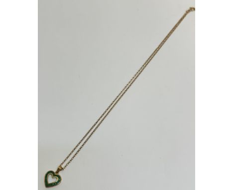 A 9ct gold open work heart shaped pendant set eighteen calibre set emeralds mounted on trace link chain, (l  1.5cm excluding 