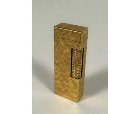 A Dunhill Vintage Swiss made gilt metal hatched design petrol lighter. stamped verso. No box. (h 6.5cm x l 2.5cm x d 1cm)