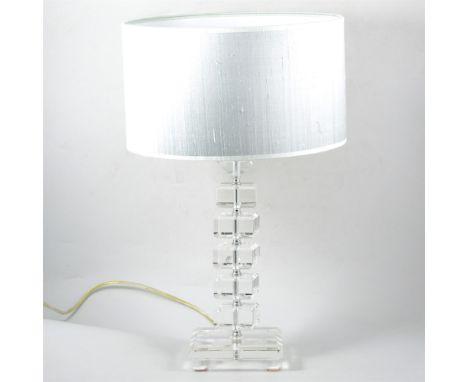 A modern table lamp, clear perspex column on a glass base, with metallic silver shade, 56cm overall.